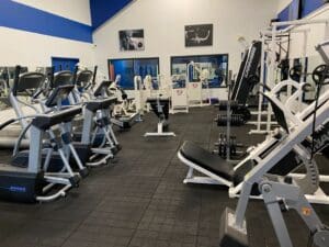A gym with many different machines in it